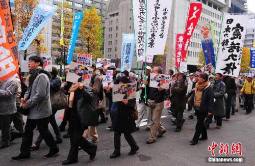 資料圖：來自日本各地的數千名市民組織“守護憲法第九條之會”人士，在東京市中心的日比谷公園內舉行大型集會，并在之后沿銀座、有樂町等繁華街區游行，呼吁守護和平憲法，反對解禁集體自衛權。中新社發 王健 攝