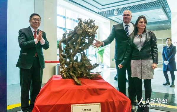 中國僑聯副主席喬衛（左）與捐贈人夫婦為九龍木雕揭幕