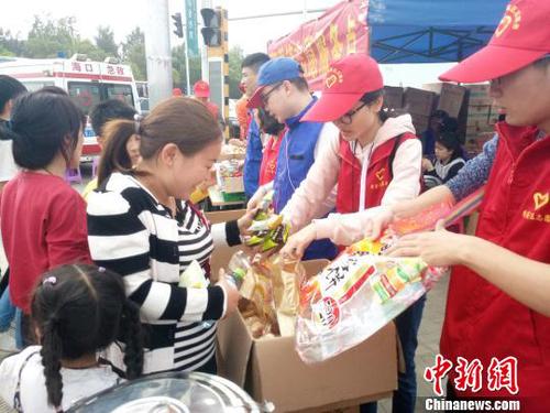 2月21日，海口新海港附近，志愿者為旅客發放食物。　尹海明 攝