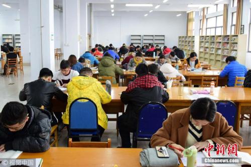 資料圖：2017年11月22日，山東青島，考研生在圖書館內(nèi)埋身書海認(rèn)真復(fù)習(xí)。小老茂 攝 圖片來源：視覺中國(guó)