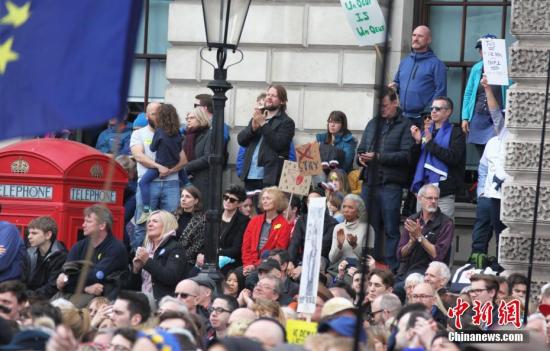 3月23日，在歐盟同意英國延遲脫歐、英國脫歐前景仍面臨“災難的不確定性”困境之際，倫敦市中心舉行了大規模呼吁舉行“第二次脫歐公投”的示威游行。名為“交給人民”的組織者聲稱，參加示威游行的英國民眾來自全國各地，超過一百萬人。圖為示威游行隊伍聚集在市中心議會廣場，密集的人群里三層外三層，水泄不通。<a target='_blank' href='http://www.chinanews.com/'>中新社</a>記者 張平 攝