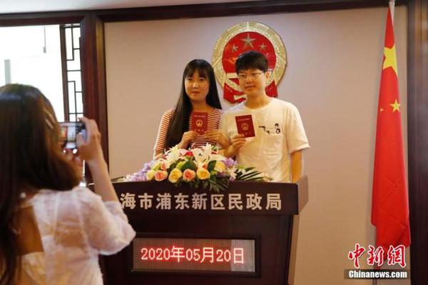 資料圖：兩位市民手持結婚證合影留念。 殷立勤 攝